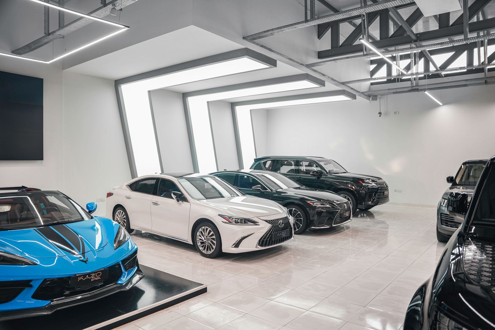 Obsidian Auto Studio bay with cars under inspection lighting